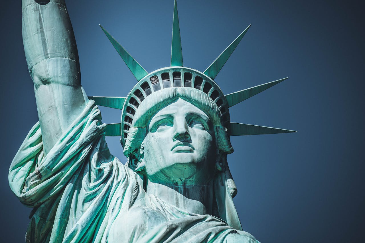 Detailed view of the iconic Statue of Liberty in New York City under a clear blue sky.